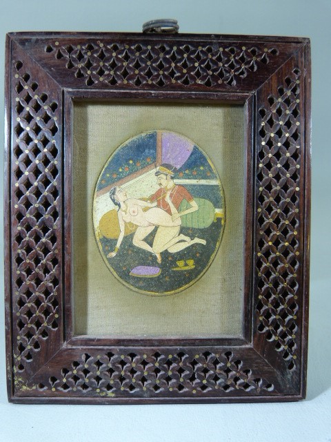 Indian Mughal watercolour on an oval panel depicting an Erotic scene