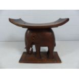 Stool with the base in the form of an elephant with planked top.