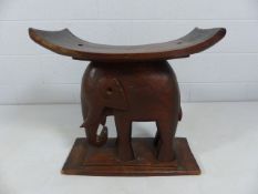 Stool with the base in the form of an elephant with planked top.