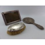 Silver backed dressing table mirror A/F, Silver backed hair brush and a hallmarked silver photo