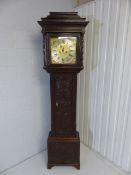 Oak longcase clock with carved case and door. Silvered Dial ring with roman numerals and highlighted