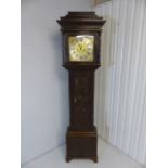 Oak longcase clock with carved case and door. Silvered Dial ring with roman numerals and highlighted