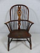 A late 18th century elm and ash wheelback elbow chair