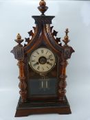 Rosewood and Mahogany Mantle clock of Architectural form. Spired top with Roman Numeral Chapter