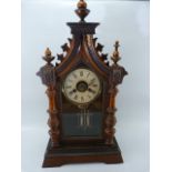 Rosewood and Mahogany Mantle clock of Architectural form. Spired top with Roman Numeral Chapter