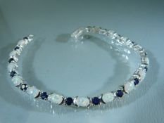 Silver (925) Tennis style Bracelet set with Sapphire and Opal. Approx weight - 13.9g