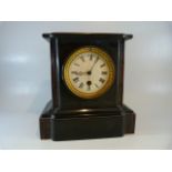 Slate mantle clock with white enamelled dial and Roman numeral Chapter ring. Maker mark rubbed