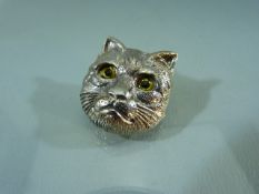 Hallmarked silver (Sterling) brooch in the form of a cats head. The eyes inset with glass. Approx