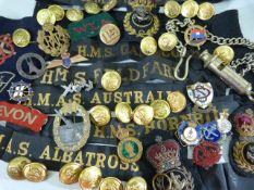 Military: Large collection of Naval and military insignia including cap badges, arm bands, hat