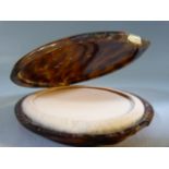 Tortoise shell cased powder compact