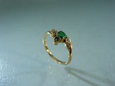 18ct Yellow Gold Emerald and Diamond crossover style ring. Approx weight - 2g