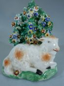 Staffordshire Pearlware figure of a recumbent lamb laying by Bocage. The Lambs coat with 'rust'