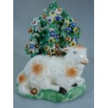 Staffordshire Pearlware figure of a recumbent lamb laying by Bocage. The Lambs coat with 'rust'