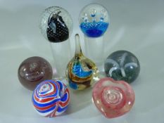 Seven glass paperweights to include Caithness etc