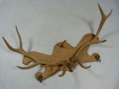 Antlers mounted on a set of coat hooks