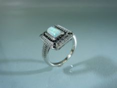 Silver CZ and Sapphire ring set with central opal panel. Approx weight - 5g