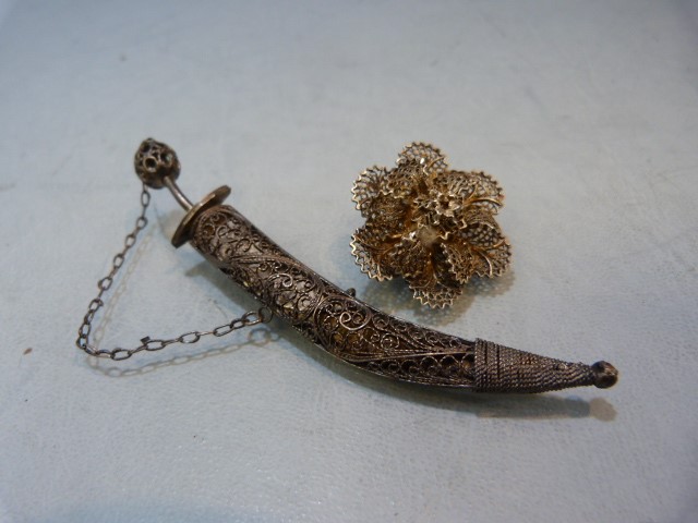 Unmarked white metal filigree knife and a filigree flower brooch