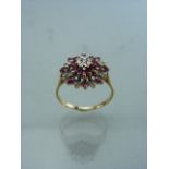 9ct Gold Ruby and Diamond ‘Target’ Dress Ring. Central small Diamond set in a white gold illusion
