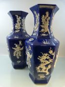 A Pair of Chinese Blue and White Hexagonal vases with depictions of dragons created with raised