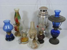Lovely selection of coloured glass oil lamps to include Bristol Blue glass, end of day style glass