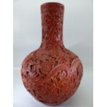 Chinese Red heavily carved vase of Globular form with impressed mark to base Qianlong