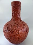 Chinese Red heavily carved vase of Globular form with impressed mark to base Qianlong