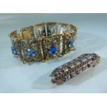Filigree panel bracelet set with blue stones along with a similar brooch with yellow metal back.