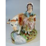 Staffordshire Prattware figure group of a cow and attendant milk maid. The naturalistic base