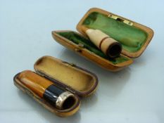 Two Cheroot/ cigarette holders with amber and silver both cased