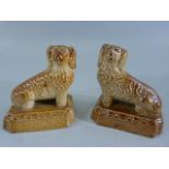 A pair of early salt glaze Brampton stoneware miniature dogs, in a sitting pose