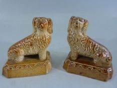 A pair of early salt glaze Brampton stoneware miniature dogs, in a sitting pose