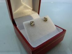 Pair of White Gold and Diamond stud solitaire earrings of approx .77pts