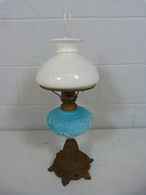 Oil Lamp with frosted shade and clear chimney and blue glass well, moulded with scrolls. Standing on