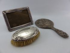 Silver backed dressing table mirror A/F, Silver backed hair brush and a hallmarked silver photo