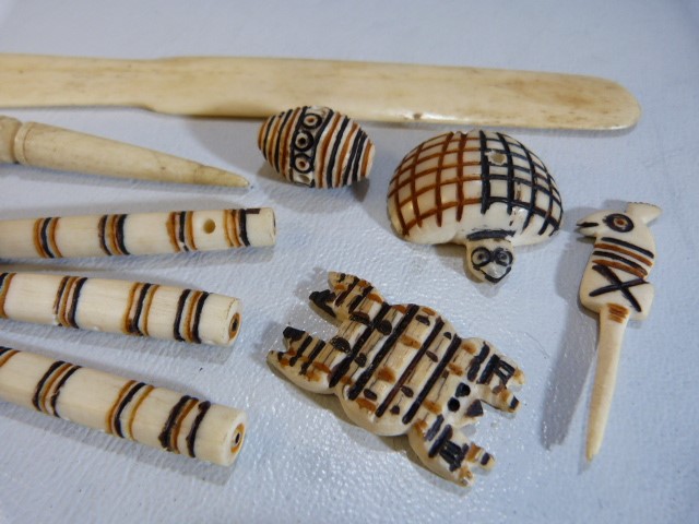 Carved bone African pendants, paper knife etc - Image 3 of 5