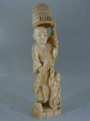 19th Century bone figure of a Japanese man carrying a lobster pot