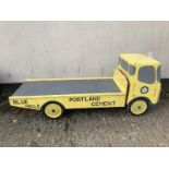 A decorative wooden model of a Portland Cement flatbed truck.