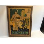 An original Michelin pictorial poster, dated 1925 depicting Mr. Bibendum beside a motorcar, framed