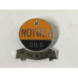 A Notwen Oils enamel lapel badge with H. Newton name bar.