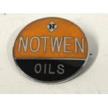 A Notwen Oils circular enamel badge.