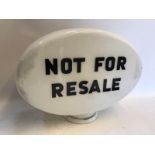 An oval glass petrol pump globe with 'Not for Resale' lettering to both sides, the globe by