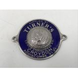 A blue enamel dealer's supply plate, for Turner's of Lower Addiscombe Road, Croydon, with central