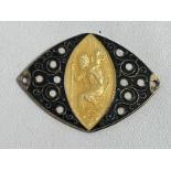 An unusual yellow enamel and filigree work silver fronted oval St. Christopher badge.