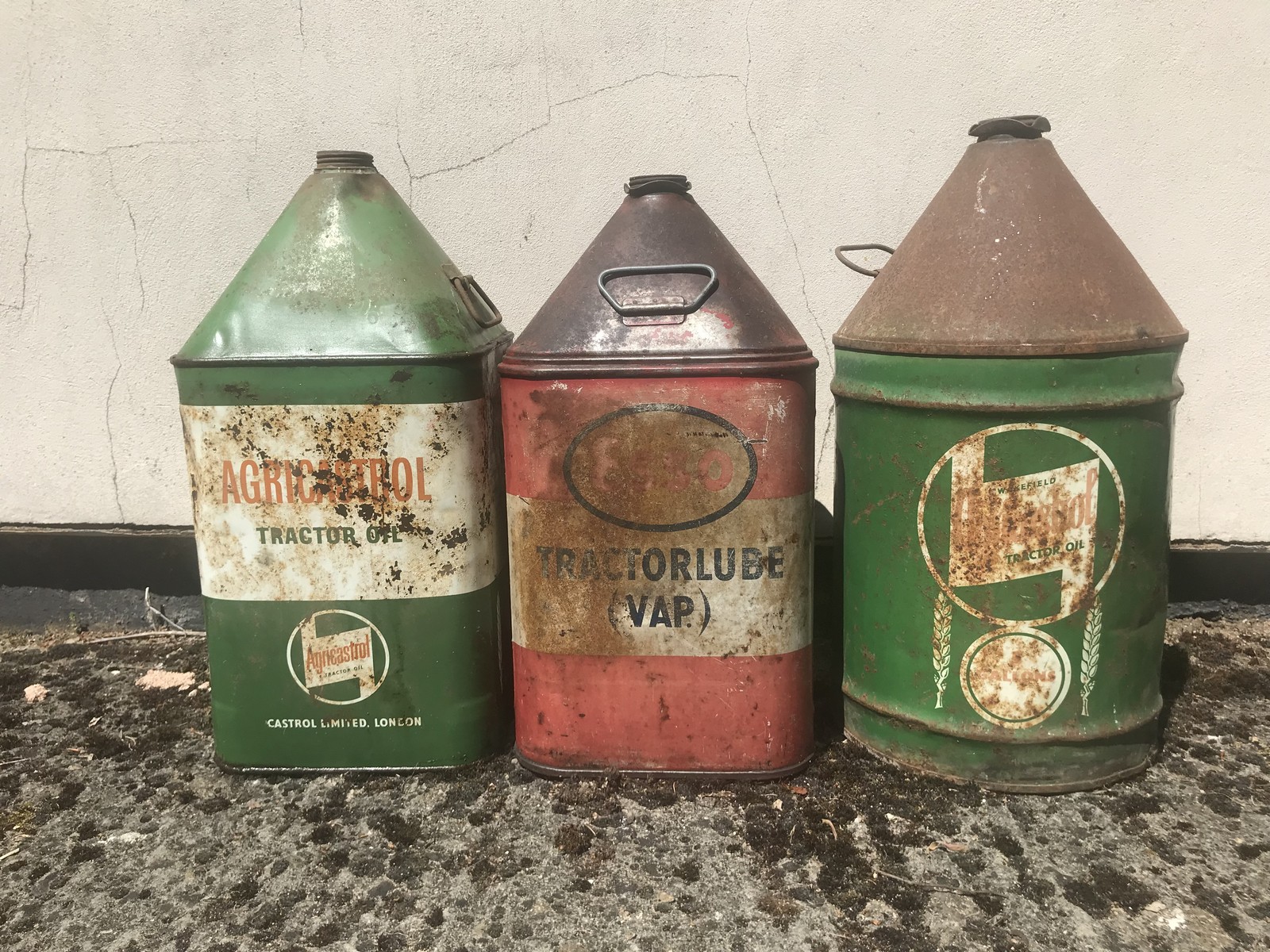 Two Agricastrol five gallon pyramid cans and an Esso Tractorlube (VAP) five gallon pyramid can.