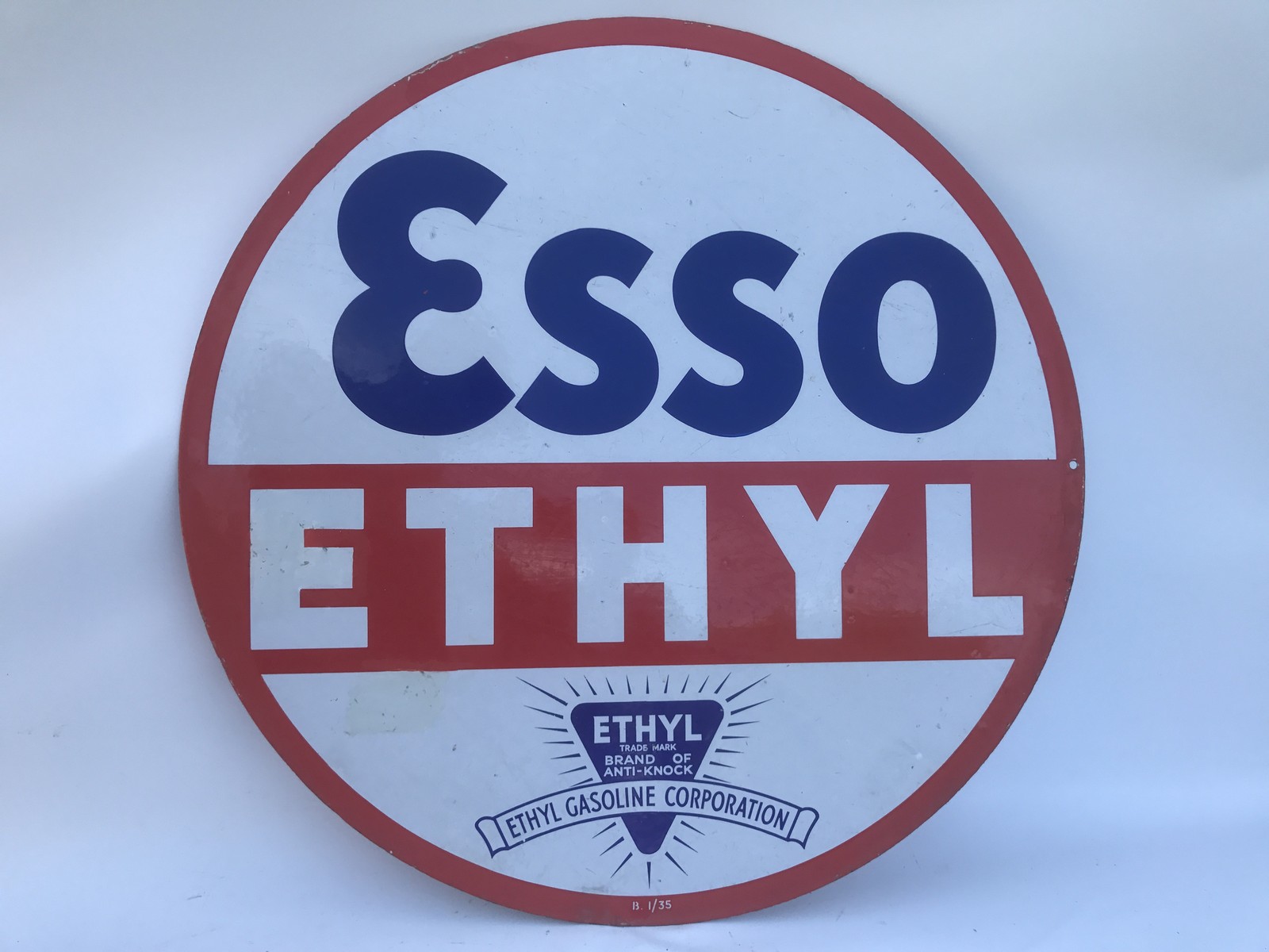 An Esso Ethyl circular double sided enamel sign dated January 1935 with two spots repaired and