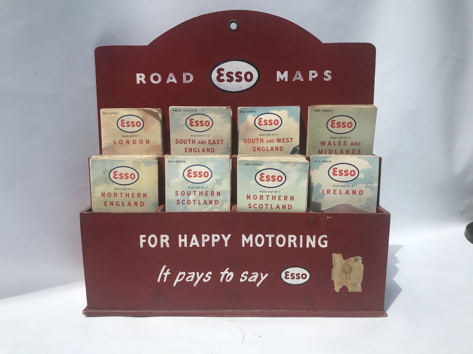 An Esso painted hardboard counter top road map dispenser with assorted early Esso maps.