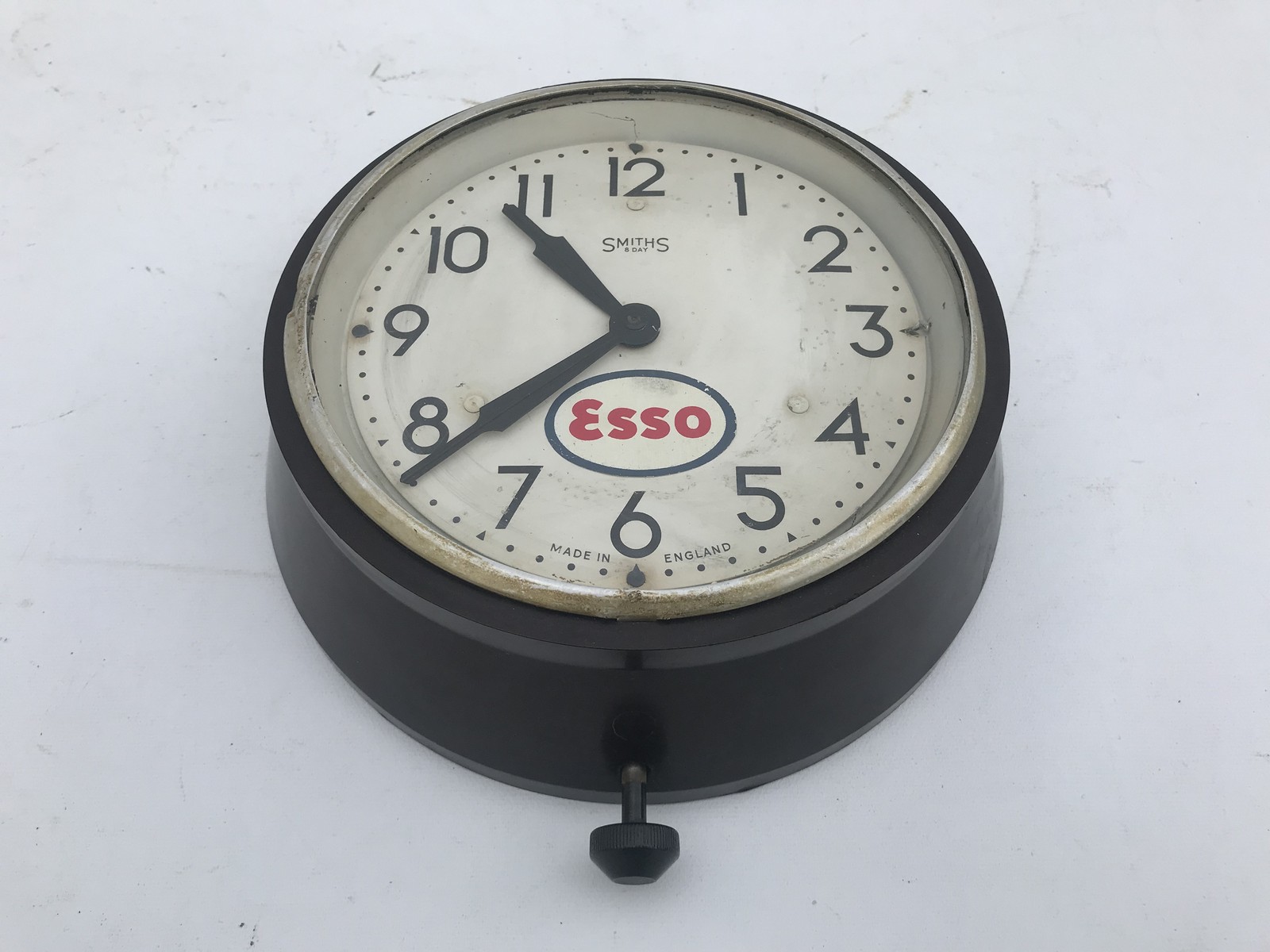 A Smiths Esso-branded wall clock in bakelite case, by repute working.