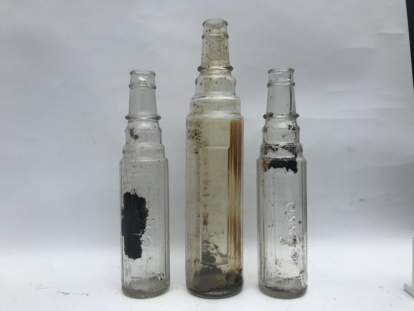 Three Esso oil bottles.