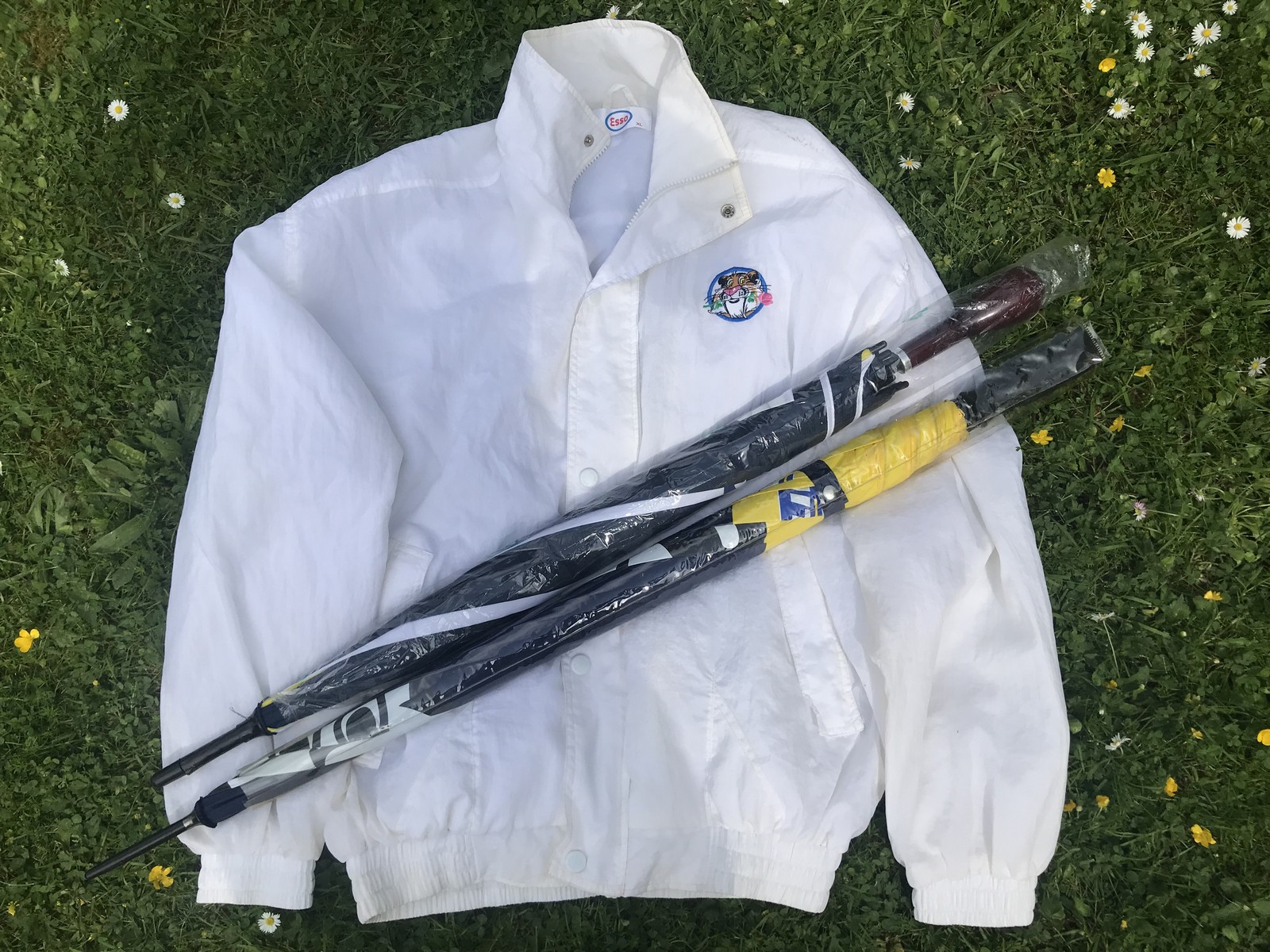 An Esso 'Tiger in your tank' promotional jacket and two promotional umbrellas.