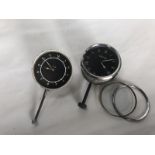 A Jaeger black faced eight day car clock and one other marked OS to the dial.